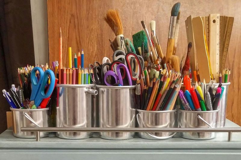 pots of paint brushes and pencils