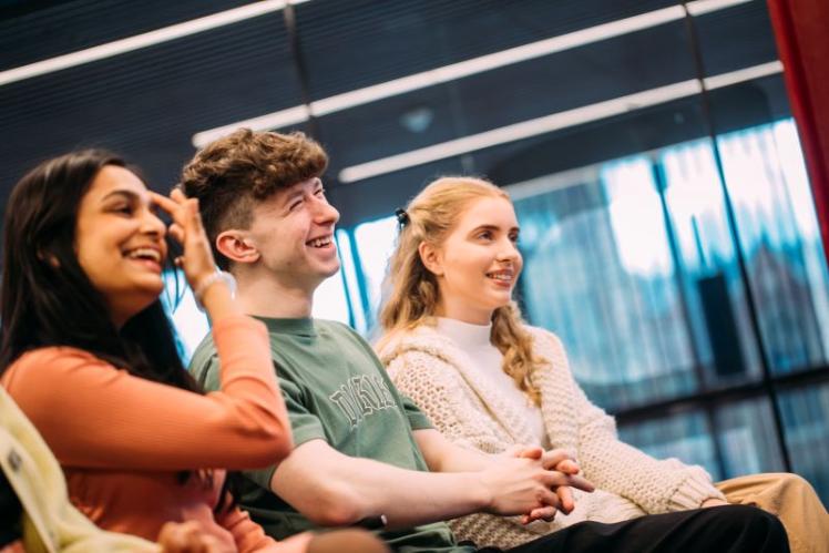 students listening to a person and laughing